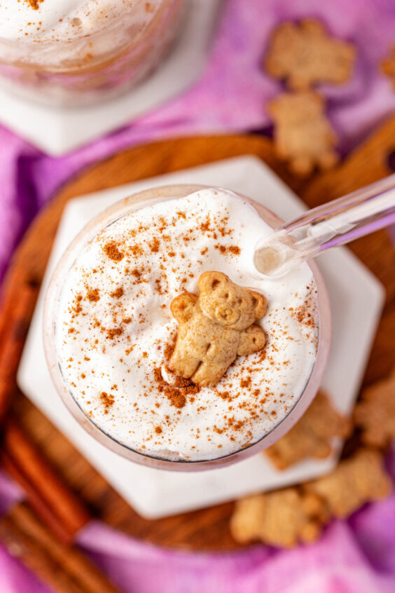 Overhead photo of a teddy graham latte on a coaster.